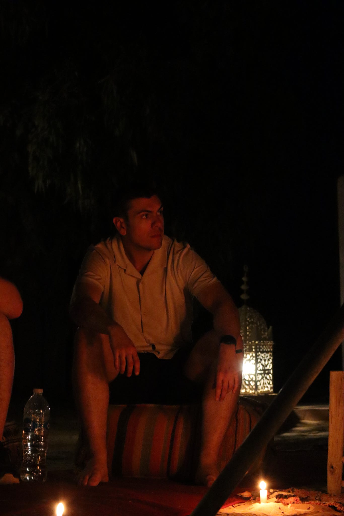 Tommy, Paws & Peaks co-founder, beside a campfire